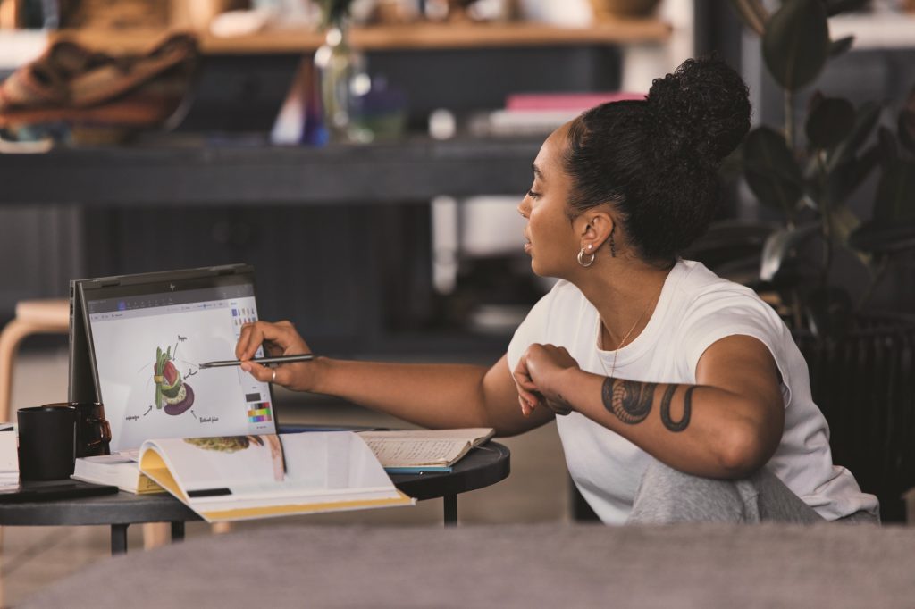 Black woman sketching on HP Envy x360